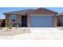 Charming single-story home with a two-car garage, desert landscaping and stone veneer accents at 37140 W Prado St, Maricopa, AZ 85138