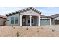Charming single-story home featuring a stylish covered entry, two-car garage, and desert landscaping at 42064 N Golden Trl, San Tan Valley, AZ 85140