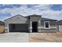 Charming single-story home with a stucco exterior, arched entry, and attached carport at 5712 E Axle Ln, San Tan Valley, AZ 85140