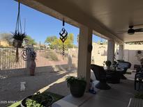 Relaxing covered patio with ceiling fan, mature desert landscaping and view at 6214 E Sierra Morena St, Mesa, AZ 85215