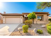 Charming single-story home featuring desert landscaping and a welcoming two-car garage at 15140 E Staghorn Dr, Fountain Hills, AZ 85268