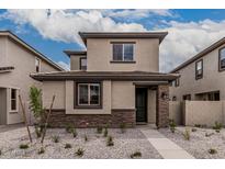Inviting two-story home with stylish stone accents and low maintenance gravel front yard at 15587 S 180Th Ln, Goodyear, AZ 85338