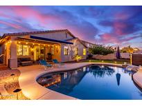 Beautiful backyard featuring a private pool, covered patio, and lounge chairs at 196 W Yellow Wood Ave, San Tan Valley, AZ 85140
