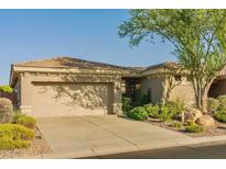 Charming home with a two-car garage, landscaped yard, and inviting curb appeal at 41814 N Crooked Stick Rd, Anthem, AZ 85086