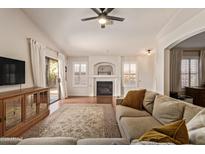 Cozy living room showcases a fireplace, modern entertainment center and plush seating perfect for relaxation at 6061 E Rochelle St, Mesa, AZ 85215