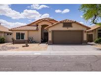 Charming single-story home with a well-manicured desert landscape at 4529 E Thistle Landing Dr, Phoenix, AZ 85044
