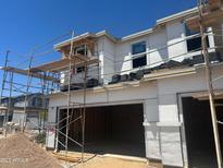Construction view of a two-story home's exterior showing window and garage door installations at 5820 E Covey Ln, Phoenix, AZ 85054