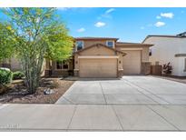 Charming home with a three-car garage, manicured landscaping, and a beautiful blue sky backdrop at 12217 W Planada Ln, Sun City, AZ 85373