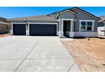Charming single-story home with a two-car garage and covered entryway, blending style and functionality at 12473 E Bahia Ct, Florence, AZ 85132