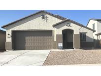 Charming single-story home with a neutral color scheme, attached two-car garage, and low-maintenance gravel landscaping at 25336 W Bowker St, Buckeye, AZ 85326