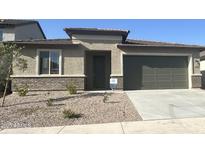 Single-story home features stucco siding, brick accents, desert landscaping, and a two-car garage at 25342 W Bowker St, Buckeye, AZ 85326