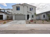 Charming two-story home with a gray stucco exterior, two-car garage, and low-maintenance landscaping at 2557 E Music Mountain Ave, Apache Junction, AZ 85119