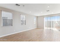 A brightly lit living room with tile flooring and a sliding glass door at 5852 E Covey Ln, Phoenix, AZ 85054