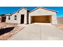 An attractive single-Gathering home shows a large driveway and a convenient two-car garage at 12246 E Agave Ln, Florence, AZ 85132