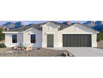 New modern single-story home with a two-car garage and desert landscaping, set against a backdrop of mountains at 12246 E Agave Ln, Florence, AZ 85132