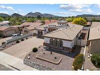 Stunning aerial view of a property with desert landscaping, a tile roof, and paver driveway at 14112 N 12Th St, Phoenix, AZ 85022