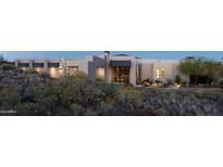 Stunning exterior view of a modern home with desert landscaping at dusk at 15332 E Hidden Springs Trl, Fountain Hills, AZ 85268