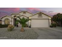 Charming single-story home boasts a well-maintained front yard with desert landscaping and a two-car garage at 18001 N 44Th Way, Phoenix, AZ 85032
