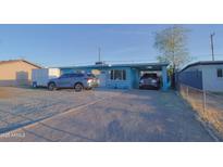 Charming single-story home featuring light blue paint, a covered carport, and low-maintenance desert landscaping at 2305 E Southern Ave, Phoenix, AZ 85040