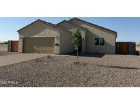 Charming single-story home featuring a two-car garage and low maintenance desert landscaping at 26308 W Camino Del Sol --, Casa Grande, AZ 85193