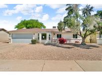 Charming single-story home with a well-maintained front yard and a two-car garage at 332 E Houston Ave, Gilbert, AZ 85234