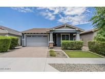 Charming single-story home featuring a well-manicured lawn and an attached two-car garage at 3386 E Strawberry Dr, Gilbert, AZ 85298