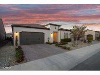 Beautiful single-story home featuring desert landscaping, a two-car garage, and an inviting entryway at 644 E Las Puertas Ln, Queen Creek, AZ 85140