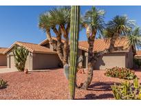 Inviting front yard featuring unique desert landscaping and a well-maintained exterior at 9234 W Sierra Pinta Dr, Peoria, AZ 85382
