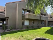 Inviting exterior of home with manicured lawn and lovely balcony at 1432 W Emerald Ave # 686, Mesa, AZ 85202