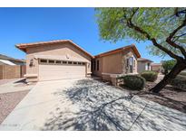 Charming single-story home with a two-car garage and well-maintained landscaping at 17050 W Manchester Dr, Surprise, AZ 85374