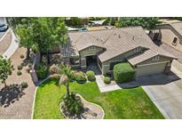 Beautiful home featuring a tile roof, lush landscaping, and backyard pool at 2585 E Morgan Dr, Gilbert, AZ 85295