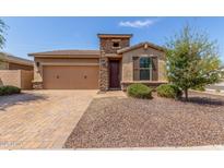 Charming single-story home featuring a stone facade, two-car garage, and desert landscaping for low maintenance at 296 N Jesse St, Chandler, AZ 85225
