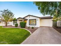 Charming single-story home featuring a well-manicured lawn, attached garage, and inviting curb appeal at 3517 E Monterosa St, Phoenix, AZ 85018