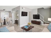 Bright living room showcasing an open floor plan with wood floors, modern décor, and a stairway to the second level at 3605 W Bethany Home Rd # 7, Phoenix, AZ 85019