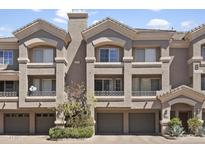 Charming three-story townhouse with an attached garage in a well-maintained community at 4455 E Paradise Village Pkwy # 1051, Phoenix, AZ 85032