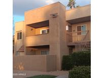 Charming two-story exterior with a balcony, desert landscaping, and warm, inviting architectural details at 5877 N Granite Reef Rd # 2257, Scottsdale, AZ 85250