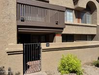 Exterior view of condo featuring a private balcony, gated patio, and lush landscaping at 700 E Mesquite Cir # N125, Tempe, AZ 85288