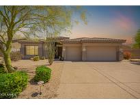 Inviting single-story home with a neutral color scheme, three-car garage, and desert landscaping at 9747 S 182Nd Dr, Goodyear, AZ 85338