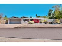 Charming single story home featuring desert landscaping, a two car garage, and solar panels at 11035 N 37Th St, Phoenix, AZ 85028