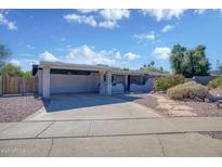 Single Gathering home featuring a two-car garage and charming desert landscaping on a sunny day at 11035 N 37Th St, Phoenix, AZ 85028