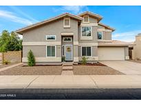 Charming two-story home featuring a well-manicured front yard, gray exterior, and a welcoming entrance with a lovely wreath at 1138 E Liberty Shores Dr, Gilbert, AZ 85234