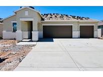 Charming single-story home featuring a two-car garage and a spacious driveway on a clear, sunny day at 12485 E Bahia Ct, Florence, AZ 85132