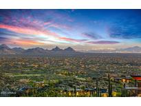 Breathtaking sunset view from this hillside home overlooking city lights and mountain ranges at 43105 N 102Nd St, Scottsdale, AZ 85262
