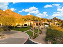 Stunning home with lush landscaping, circular driveway, and desert mountain views at 6621 N Arizona Biltmore Cir, Phoenix, AZ 85016