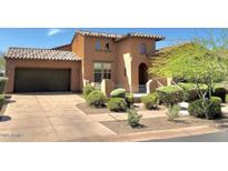 Charming home with a tile roof, stucco exterior, arched entry, and landscaped front yard at 9209 E Desert Arroyos --, Scottsdale, AZ 85255