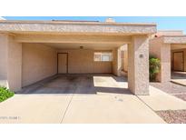 Spacious carport providing covered parking and easy access to the home's entrance at 10 E Betty Elyse Ln, Phoenix, AZ 85022