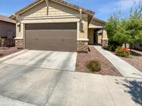 Charming single-story home featuring a two-car garage and low maintenance desert landscaping at 14154 W Voltaire St, Surprise, AZ 85379