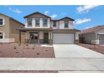 Charming two-story home featuring desert landscaping and a two car garage at 17250 W Via Dona Rd, Surprise, AZ 85387
