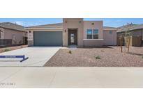 Inviting single-Gathering home featuring a two-car garage and low-maintenance desert landscaping at 17429 W Via Dona Rd, Surprise, AZ 85387