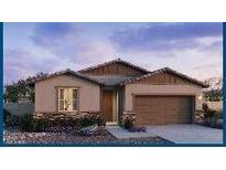 Charming single-story home featuring stone accents, a two-car garage, and a welcoming front entrance at 25354 W Bowker St, Buckeye, AZ 85326
